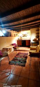 a living room with a couch and chairs and a rug at Adobe Getaway with 'private plunge pool' in Viñuela