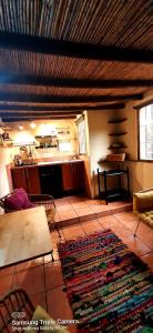 a living room with a kitchen and a rug on the floor at Adobe Getaway with 'private plunge pool' in Viñuela