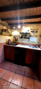 a kitchen with a sink and a stove in it at Adobe Getaway with 'private plunge pool' in Viñuela