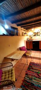 a living room with a table and chairs and a kitchen at Adobe Getaway with 'private plunge pool' in Viñuela