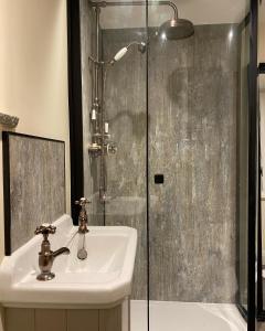 a bathroom with a sink and a shower at Cross Haw Cottage in Sedbergh +27 photos