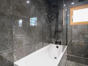 a bathroom with a bath tub and a window at Otter's View in Oakham