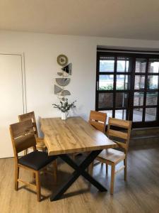 a wooden table and chairs in a room at Wohnung in Greven in Greven