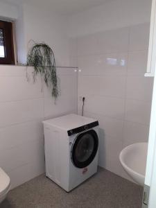 a washing machine in a bathroom next to a toilet at Wohnung in Greven in Greven
