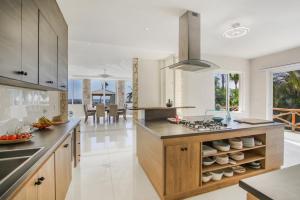 a kitchen with a large island with a counter top at Villa Okyanus with Fantastic Ocean View Chef Butler Maid Golf Cart in Punta Cana