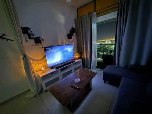 a living room with a television and a couch and a table at Studio in Fujairah,CIT&SEA view in Fujairah