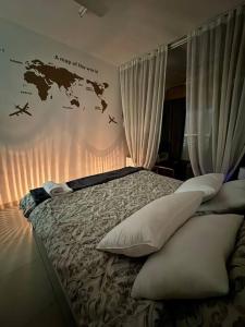 a bedroom with a bed with a map of the world on the wall at Studio in Fujairah,CIT&SEA view in Fujairah