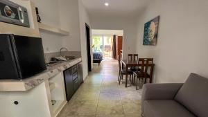 a kitchen and living room with a couch and a table at Suites Casa Blanca in La Paz
