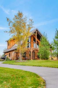 a large wooden house with a tree in front of it at Rustic Hideaway sleeps 4 Hot tub in De Soto