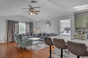 a kitchen and living room with a table and chairs at Modern Escape Cali King Beds EV Chargers Available in Lutz