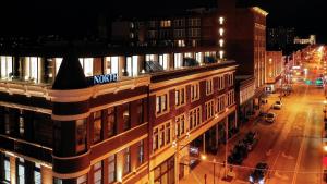 a view of a city street at night with a building at Hotel Covington Cincinnati Riverfront in Covington