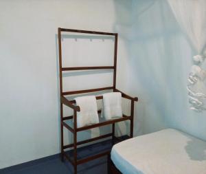 a towel rack next to a bed in a room at AB Nest Hiriketiya in Dickwella