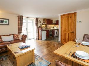 a living room with a couch and a table at Kerrowdown Mill in Inverness