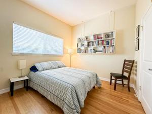 a bedroom with a bed and a book shelf at 4 BR House With Pool - BB-WW in Los Angeles