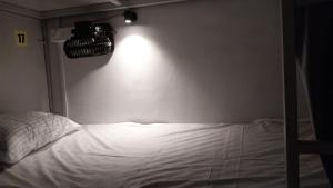 a bedroom with a bed with a camera on the wall at Saffron Dormitory Goregaon East in Mumbai