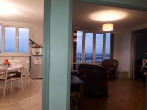 a living room and dining room with a view of the ocean at T4/5 avec vue sur les Alpes à 5 minutes de Lyon in La Mulatière