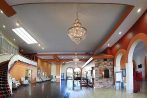 a large lobby with a chandelier and a building at Ramada by Wyndham Fresno North in Fresno