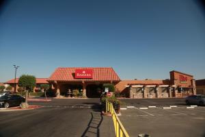 an empty parking lot in front of a restaurant at Ramada by Wyndham Fresno North in Fresno