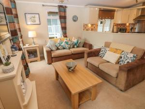 a living room with two couches and a coffee table at 16 Heritage Park in Narberth