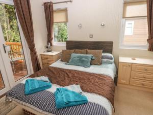 a bedroom with two beds and a balcony at 16 Heritage Park in Narberth