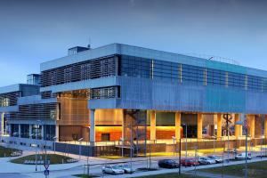 a building with cars parked in a parking lot at Trendy apartment 5 min to city centre!` in Zagreb