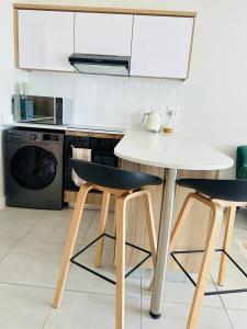 a kitchen with a white table and two chairs at Coastal Retreats in Ballito