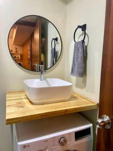 a bathroom with a sink and a mirror at Horizon 101 - champito's place in Cebu City