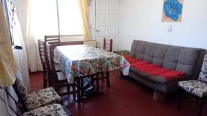 a living room with a table and a couch at El Paso in Santa Clara del Mar