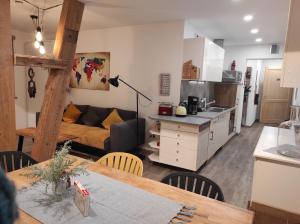 a kitchen and living room with a couch and a table at Zum Scheunenhof - Scheune in Ichenhausen