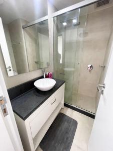 a bathroom with a sink and a shower at Hermoso departamento en Skytower in Asunción