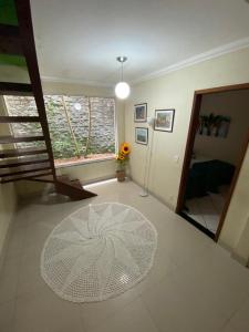 een woonkamer met een witte tafel en een raam bij Quarto Ponta Negra in Angra dos Reis