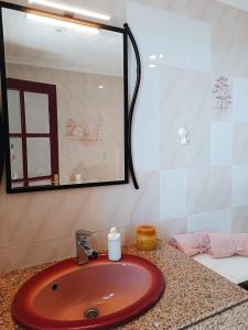 baño con lavabo rojo y espejo en Casa de Familia Felipe y Martin, en Tías