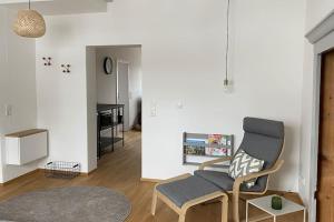 a living room with a chair and a table at nummer22 in Eschenbach in der Oberpfalz