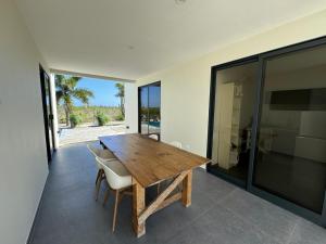 a dining room with a wooden table and chairs at Salt Apartments Bonaire in Kralendijk