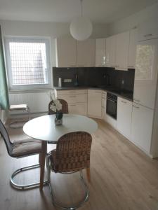 a kitchen with a table and two chairs and a table at Ferienwohnung Wiebe in Minden