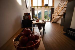a living room with a table and a basket of fruit at Bieszczadzkie Ukojenie in Ropienka
