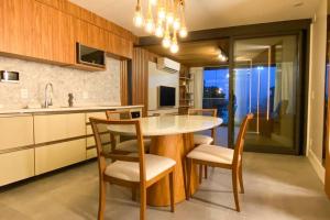 a kitchen with a table and chairs in a kitchen at Atlântico Collection in Rio de Janeiro