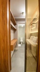 a room with a bathroom with a toilet and a hallway at Atlântico Collection in Rio de Janeiro