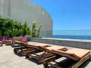 a row of tables and chairs on top of a building at Atlântico Collection in Rio de Janeiro