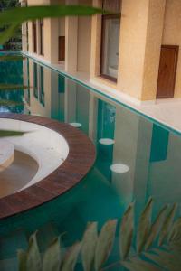 a reflection of a building in a pool of water at Spicepeek Boutique Hotel CMB Airport in Katunayaka