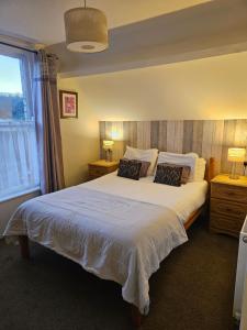a bedroom with a large white bed with two pillows at Valley Bar in Scarborough