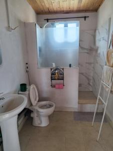 a bathroom with a toilet and a sink at Villa Fahasoavana in Antananarivo