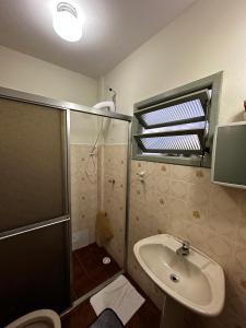 a bathroom with a shower and a sink at Hotel Mirante in Barra Velha +62 photos