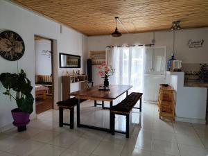 a dining room with a wooden table and chairs at Villa Fahasoavana in Antananarivo