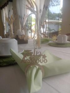 a table with a white table cloth with a napkin on it at Pousada Recanto de Praia Seca in Araruama