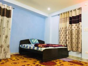 a blue room with a chair and curtains at Ali Baba Hostel in Jaipur