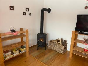 a living room with a wood stove in the corner at Chalupa Bob a Bobek in Horní Bečva