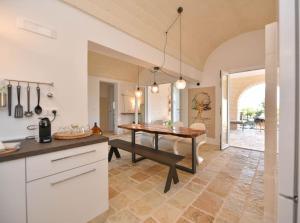 a kitchen with a table and a dining room at LàMìa Donnagnora in Ostuni