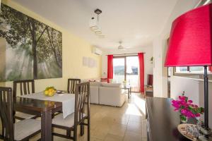 a kitchen and living room with a table and chairs at Apartamento 33, Frigiliana Spacious family Apartment with large Pool in the town center HansOnHoliday Rentals in Frigiliana