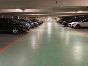 a parking garage filled with lots of parked cars at My Little House in Paris * Hypercentre * Climatisé in Paris